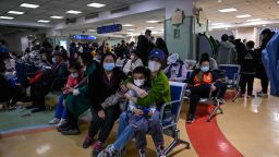 TOPSHOT - Children and their parents wait at an outpatient area at a children hospital in Beijing on November 23, 2023. The World Health Organization has asked on November 23, 2023, China for more data on a respiratory illness spreading in the north of the country, urging people to take steps to reduce the risk of infection. China has reported an increase in "influenza-like illness" since mid-October when compared to the same period in the previous three years, the WHO said. (Photo by Jade Gao / AFP) (Photo by JADE GAO/AFP via Getty Images)