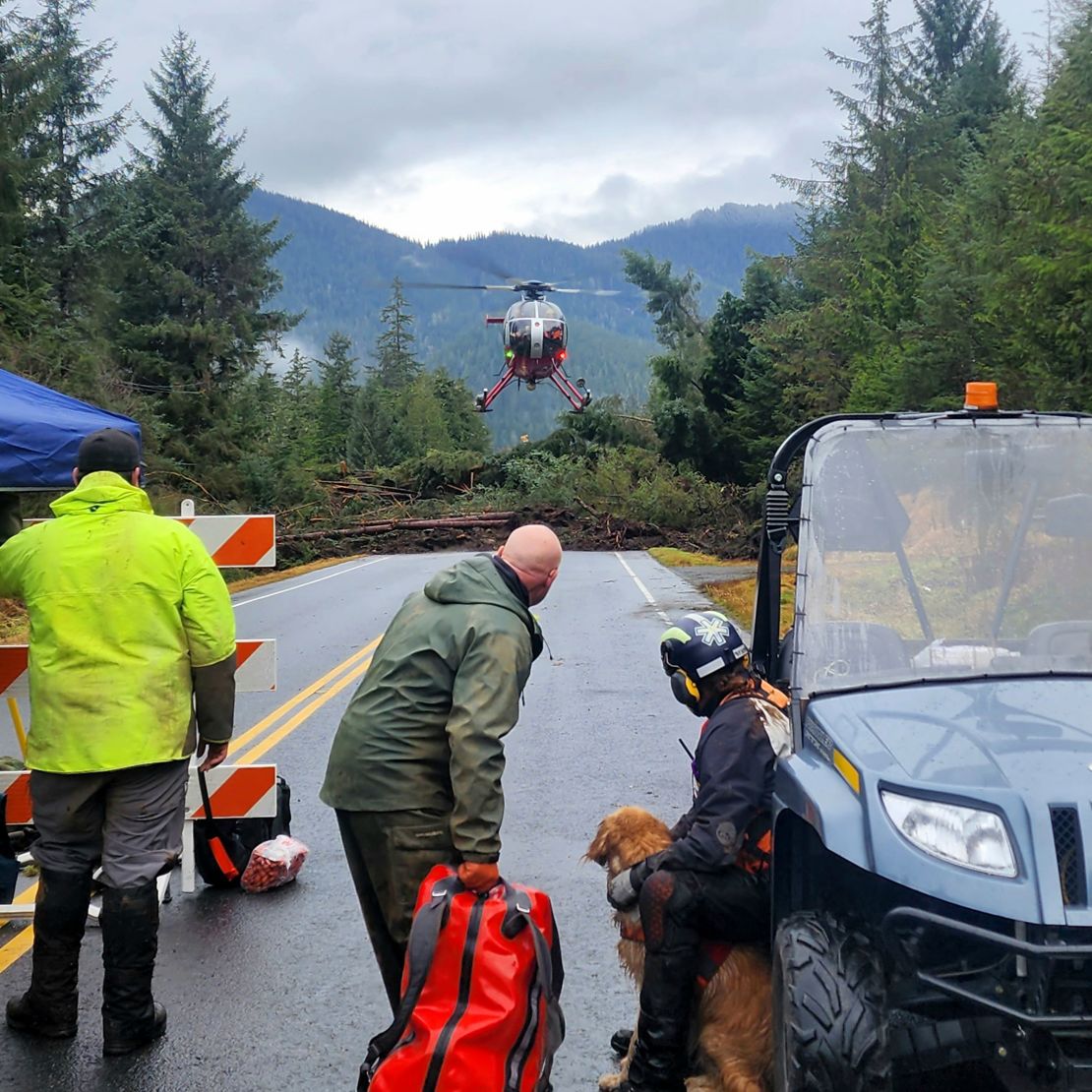 This photo provided by Division of Homeland Security and Emergency Management shows a helicopter arriving near mile 11 of the Zimovia Highway where ground teams, including search and rescue dogs, are actively working to search areas that state geologists have determined safe for entry Wednesday, Nov. 22, 2023, in Wrangell, Alaska, following a massive landslide earlier in the week. Three people have died and searchers looked Wednesday for three others who remain missing after a landslide ripped through a remote Alaska fishing community on Monday, Nov. 20, 2023. (Willis Walunga/Division of Homeland Security and Emergency Management via AP)
