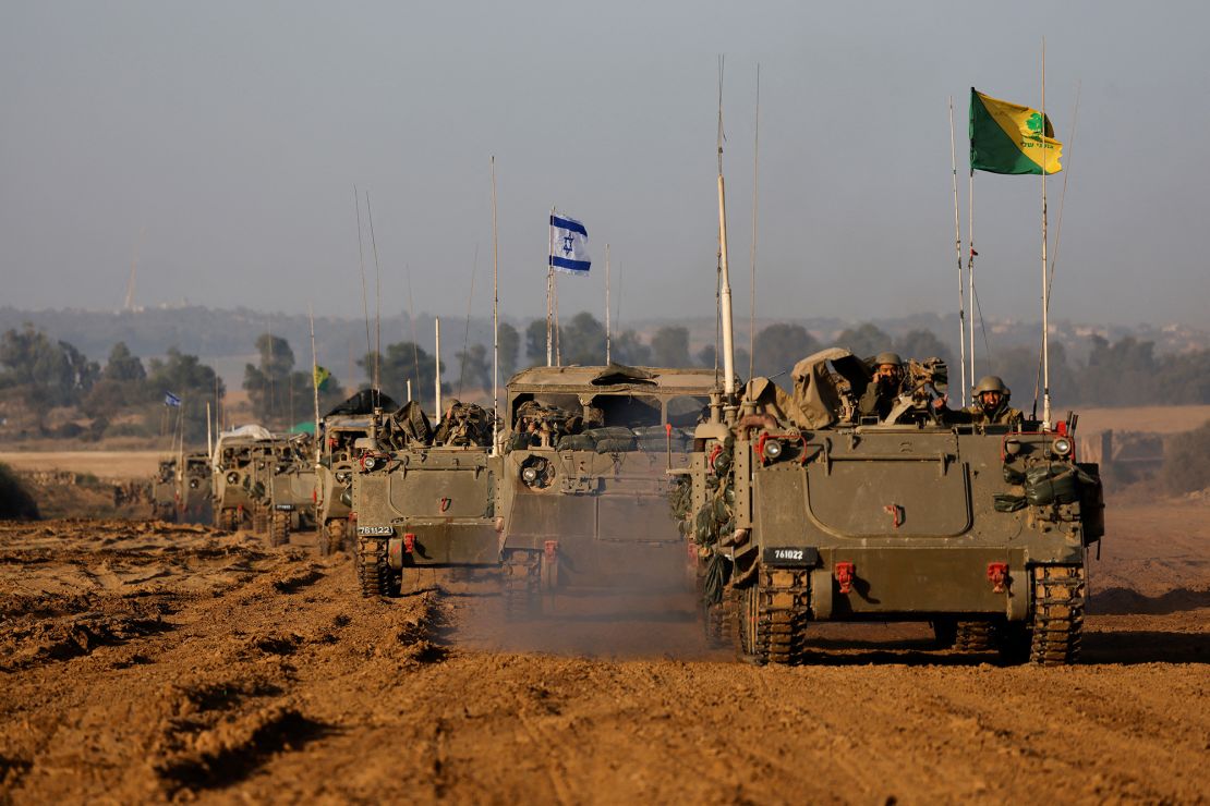An Israeli flag is seen on a military vehicle as a convoy of Israeli military tanks and Armoured Personnel Carriers (APC) drives by Israel's border after leaving Gaza during the temporary truce between Palestinian Islamist group Hamas and Israel, in Israel, November 24, 2023. REUTERS/Amir Cohen