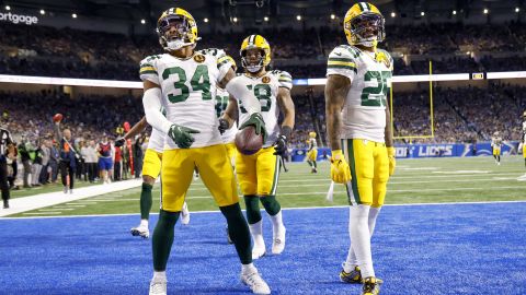 Green Bay Packers safety Jonathan Owens (34) celebrates with Green Bay Packers cornerback Keisean Nixon (25) in the first half scores a touchdown in the first half against the Detroit Lions during an NFL football game at Ford Field in Detroit, Thursday, Nov. 23, 2023. (AP Photo/Rick Osentoski)