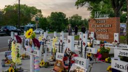 UVALDE, TEXAS - MAY 24: Law enforcement stand watch near a memorial dedicated to the 19 children and two adults murdered on May 24, 2022 during the mass shooting at Robb Elementary School on May 24, 2023 in Uvalde, Texas. Today marks the 1-year anniversary of the mass shooting at the school. 19 children and two teachers were killed when a gunman entered the school, opening fire on students and faculty. (Photo by Brandon Bell/Getty Images)