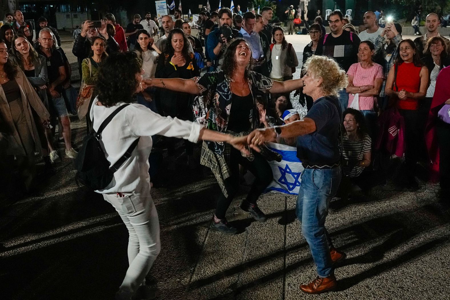 People in Tel Aviv, Israel, react as they hear the news of the release of 13 Israeli hostages held by Hamas on Friday, November 24.