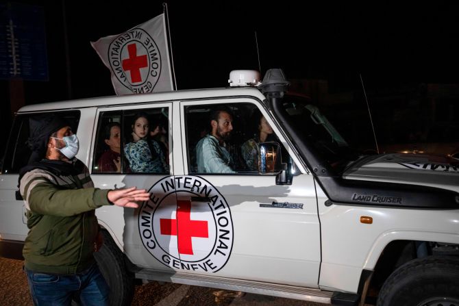 A Red Cross vehicle carrying Israeli hostages enters the Rafah border crossing late Saturday, November 25.