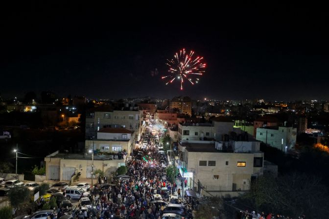 Fireworks streak across the sky as Palestinian prisoners who were released from the Israeli Ofer military facility are paraded in Beitunia, in the occupied West Bank, on November 24.