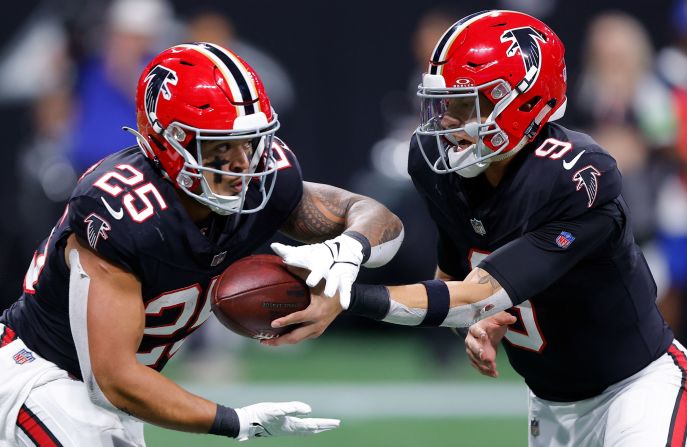 Desmond Ridder of the Atlanta Falcons hands the ball off to Tyler Allgeier during the Falcons' 24-15 victory over the New Orleans Saints on November 26.