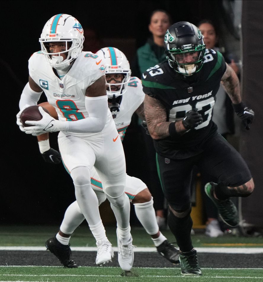 Miami Dolphins safety Jevon Holland runs the ball after intercepting New York Jets quarterback Tim Boyle's Hail Mary pass on the 1-yard line on Friday, November 24. Holland <a target="_blank">ran it to the other end of the field</a>, weaving through the scrambled defense, for an astonishing 99-yard interception touchdown. The Dolphins beat the Jets 34-13.
