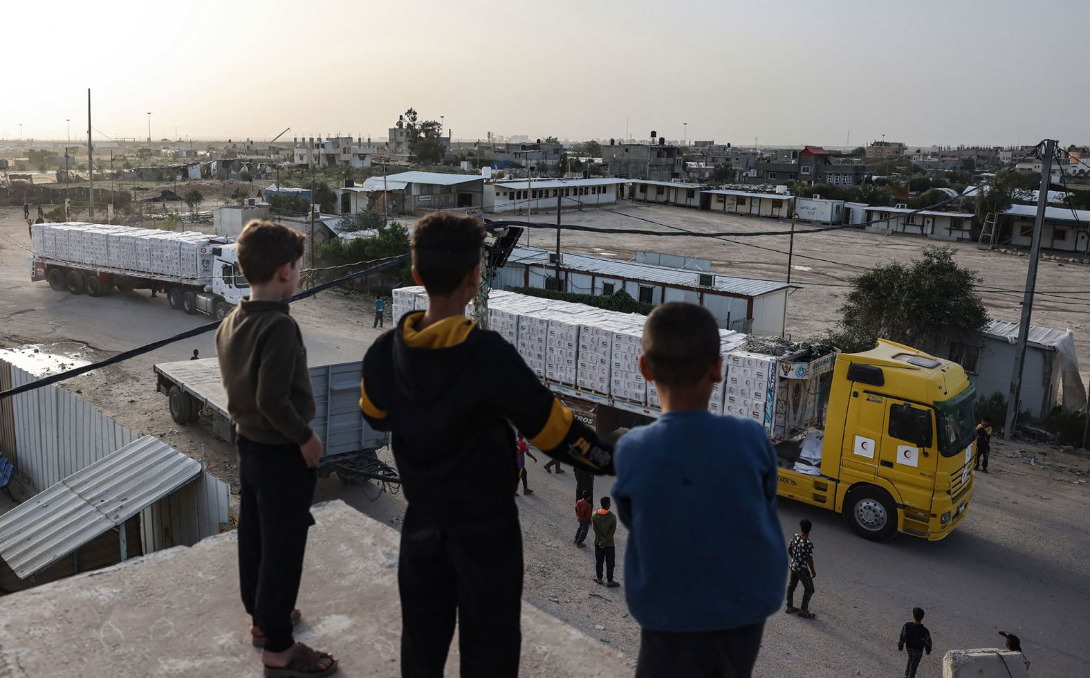 Young boys look at aid trucks entering Gaza on November 26.