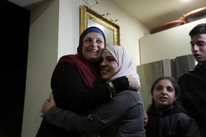 Israa Jaabis, left, a Palestinian prisoner released by Israel, is hugged as she arrives home in the East Jerusalem neighborhood of Jabel Mukaber early November 26.