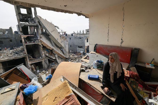 A Palestinian woman sits on debris in her damaged apartment in the Khezaa district on the outskirts of the southern Gazan city of Khan Younis on November 25. 