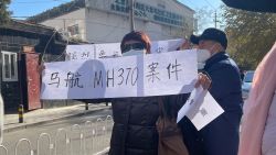 Family members stand outside the court during a hearing lawsuits against Malaysia Airlines over missing flight MH370, in Beijing on November 27, 2023.