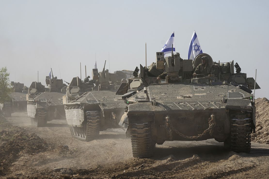 A convoy of Israeli army vehicles maneuvers near Israel's border after leaving Gaza, southern Israel, on Friday, Nov. 24, 2023. Friday marks the start of a four-day cease-fire in the Israel-Hamas war, during which the Gaza militants pledged to release 50 hostages in exchange for 150 Palestinians imprisoned by Israel. (AP Photo/Tsafrir Abayov)