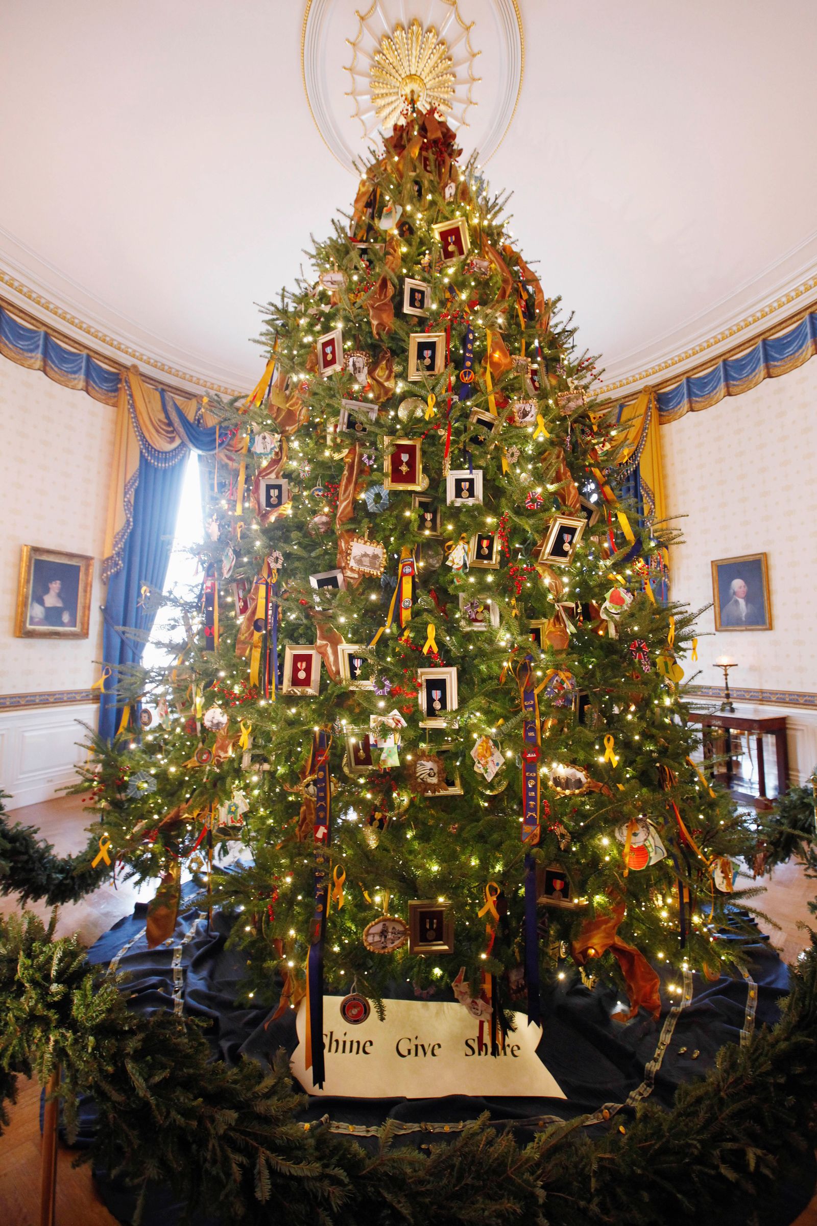 The White House Christmas Tree is seen during a press preview, Wednesday Nov. 30, 2011, in the Blue Room of the White House in Washington. The tree, whose theme is "Shine, Give, Share" honors military families. (AP Photo/Charles Dharapak)