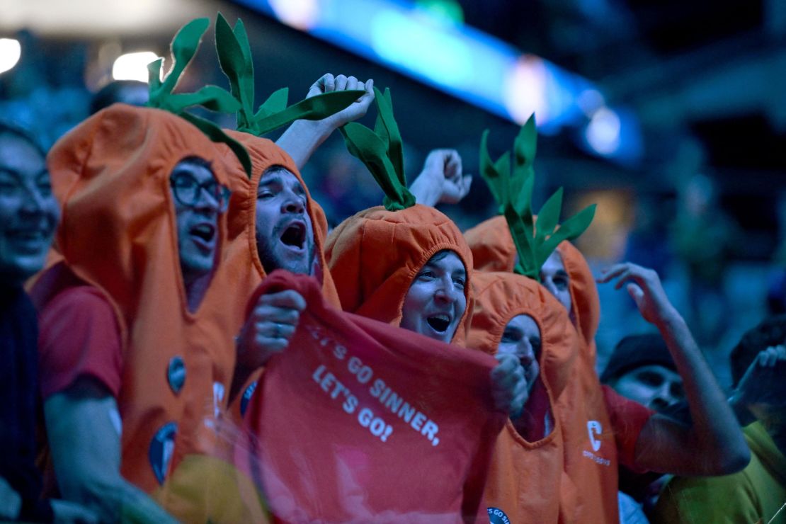 Supporters wearing carrot' costumes cheer for Italy's Jannik Sinner during the first round-robin match against Greece's Stefanos Tsitsipas at the ATP Finals tennis tournament in Turin on November 12, 2023. (Photo by Tiziana FABI / AFP) (Photo by TIZIANA FABI/AFP via Getty Images)