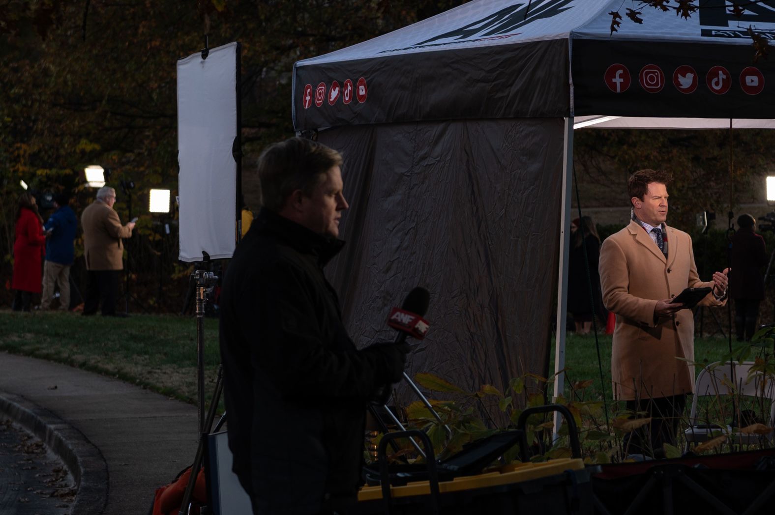 TV journalists report from outside the Carter Center in Atlanta on Monday.