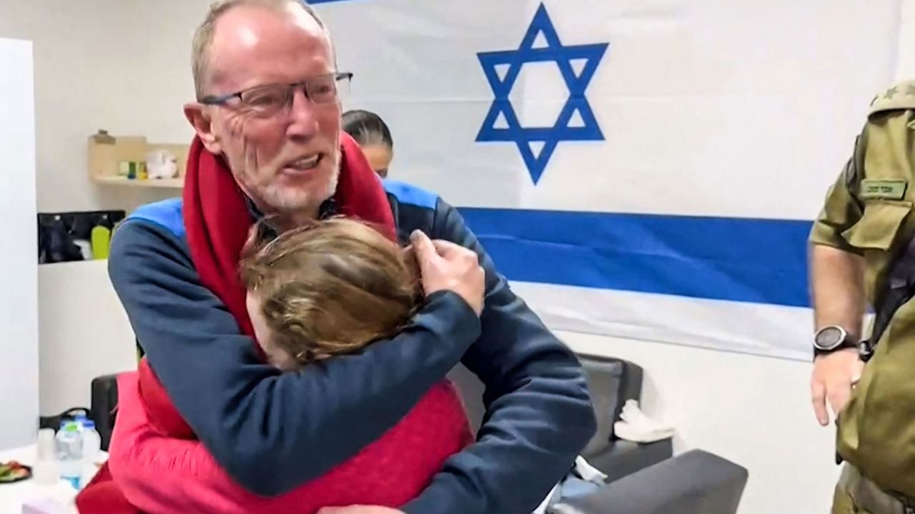 TOPSHOT - This image grab from a handout video released by the Israeli army, shows 9-year-old Irish Israeli former hostage Emily Hand embracing her father at a hospital in Israel after being released by Hamas, amid an exchange operation of hostages against prisoners between Hamas and Israel, on November 26, 2023. Hamas on November 25, released a second group of Israeli and foreign civilians it had been holding hostage in the Gaza Strip in exchange for Palestinian prisoners, after an hours-long unexpected delay set nerves on edge. Israeli authorities said 13 Israelis and four Thai citizens had returned to Israel. (Photo by Israel Army / AFP) / NO ARCHIVES -- RESTRICTED TO EDITORIAL USE - MANDATORY CREDIT "AFP PHOTO / ISRAELI ARMY" - NO MARKETING NO ADVERTISING CAMPAIGNS - DISTRIBUTED AS A SERVICE TO CLIENTS (Photo by -/Israel Army/AFP via Getty Images)