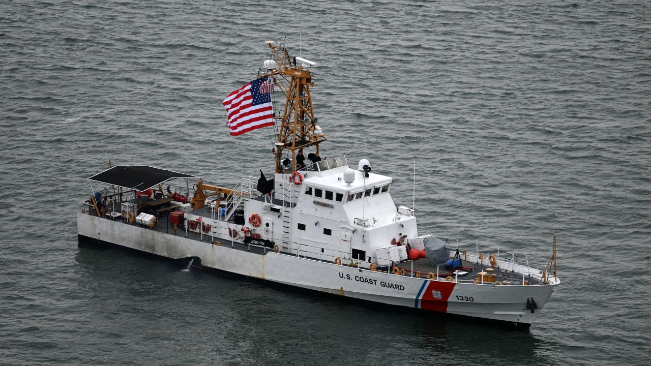 In this February 6 phtoo, a Coast Guard cutter idles near Nobska Lighthouse in Falmouth, Massachusetts. 