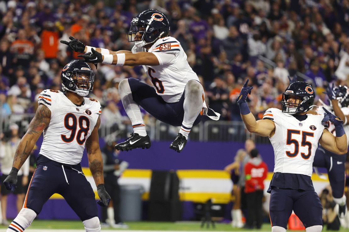 Chicago Bears cornerback Kyler Gordon (6) celebrates with teammates defensive end Montez Sweat (98) and linebacker Dylan Cole (55) after intercepting a pass during the second half of an NFL football game against the Minnesota Vikings, Monday, Nov. 27, 2023, in Minneapolis. (AP Photo/Bruce Kluckhohn)