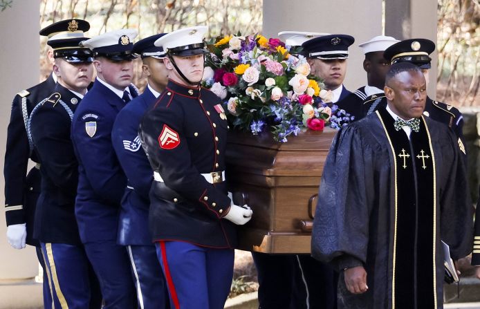 A military honor guard carries Carter's casket Tuesday at the Jimmy Carter Presidential Library and Museum in Atlanta.
