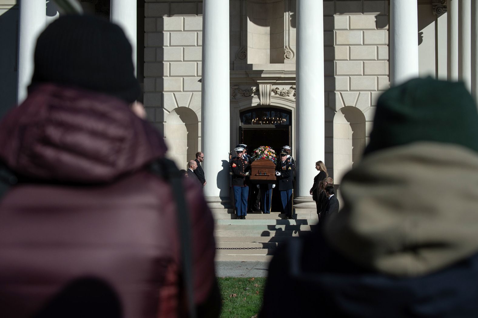 People watch as Carter's casket is carried out of the Glenn Memorial United Methodist Church in Atlanta on Tuesday. A private tribute service took place there.