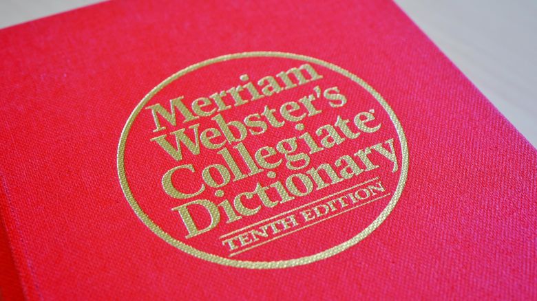 2A43ND0 PRINCETON, NJ -11 OCT 2019- View of a Merriam Websters English dictionary with a red cover on a desk.