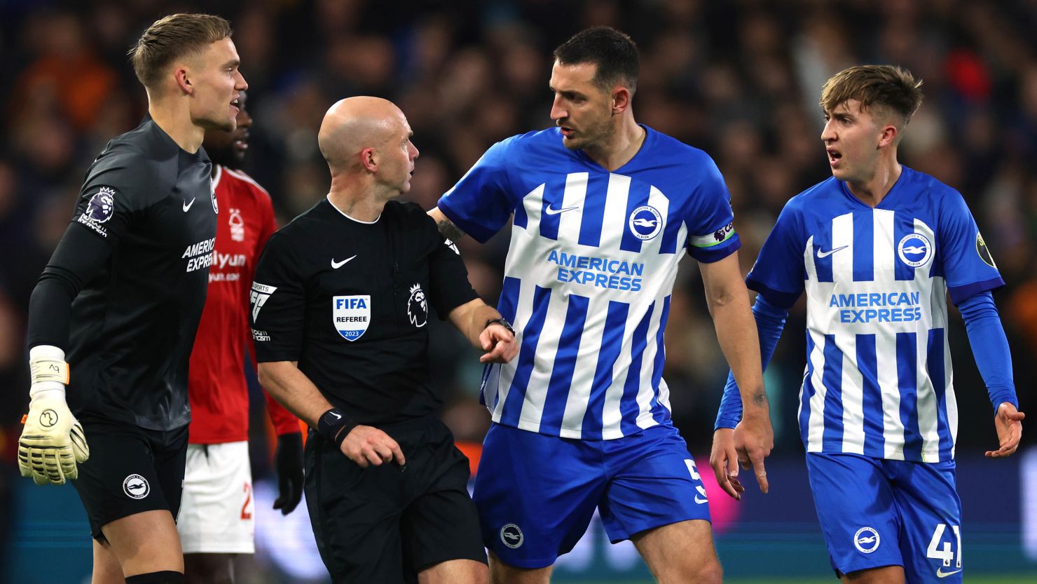 NOTTINGHAM, ENGLAND - NOVEMBER 25: Lewis Dunk of Brighton & Hove Albion talks to Referee, Anthony Taylor during the Premier League match between Nottingham Forest and Brighton & Hove Albion at City Ground on November 25, 2023 in Nottingham, England. (Photo by Eddie Keogh/Getty Images)