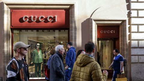 Pedestrians pass a Gucci store in downtown Rome, Italy, on Tuesday March 28, 2023.