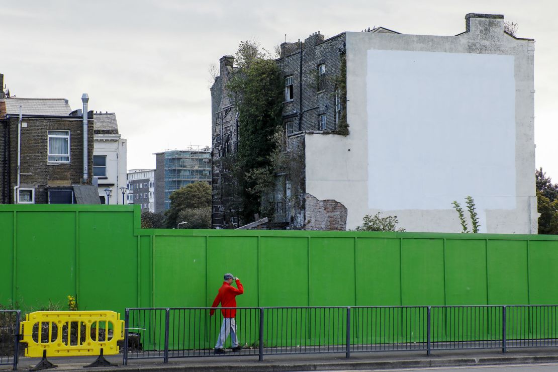 A pedestrian passes a building that until recently featured a mural by street artist Banksy depicting a European Union (EU) flag being chiseled by a workman in Dover, U.K., on Thursday, Sept. 19, 2019. The Port of Dover -- through which a sixth of the U.K.s trade in goods flows -- can cope with any disruption thrown up by a no-deal Brexit, Chief Executive Officer Doug Bannister said, suggesting some of the direr predictions of chaos are wide of the mark. Photographer: Luke MacGregor/Bloomberg via Getty Images