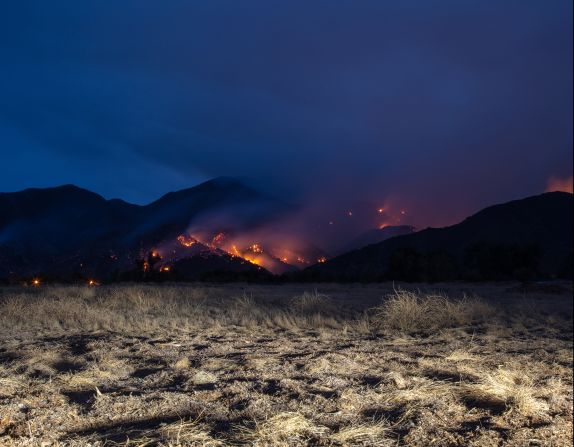 Los Angeles-based photographer and artist Kevin Cooley uses light as a medium to raise awareness of our impact on the environment around us, focusing mainly on the four elements: earth, wind, water and fire. Pictured, an image from Cooley's "Still Burning" series, which aims to help us better understand the relationship between wildfires and humanity.