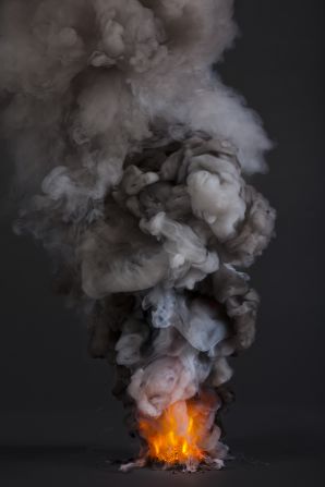 In his series "Controlled Burns" Cooley created illuminated smoke plumes in a controlled environment, a visual statement about "our desire to control nature," he said.