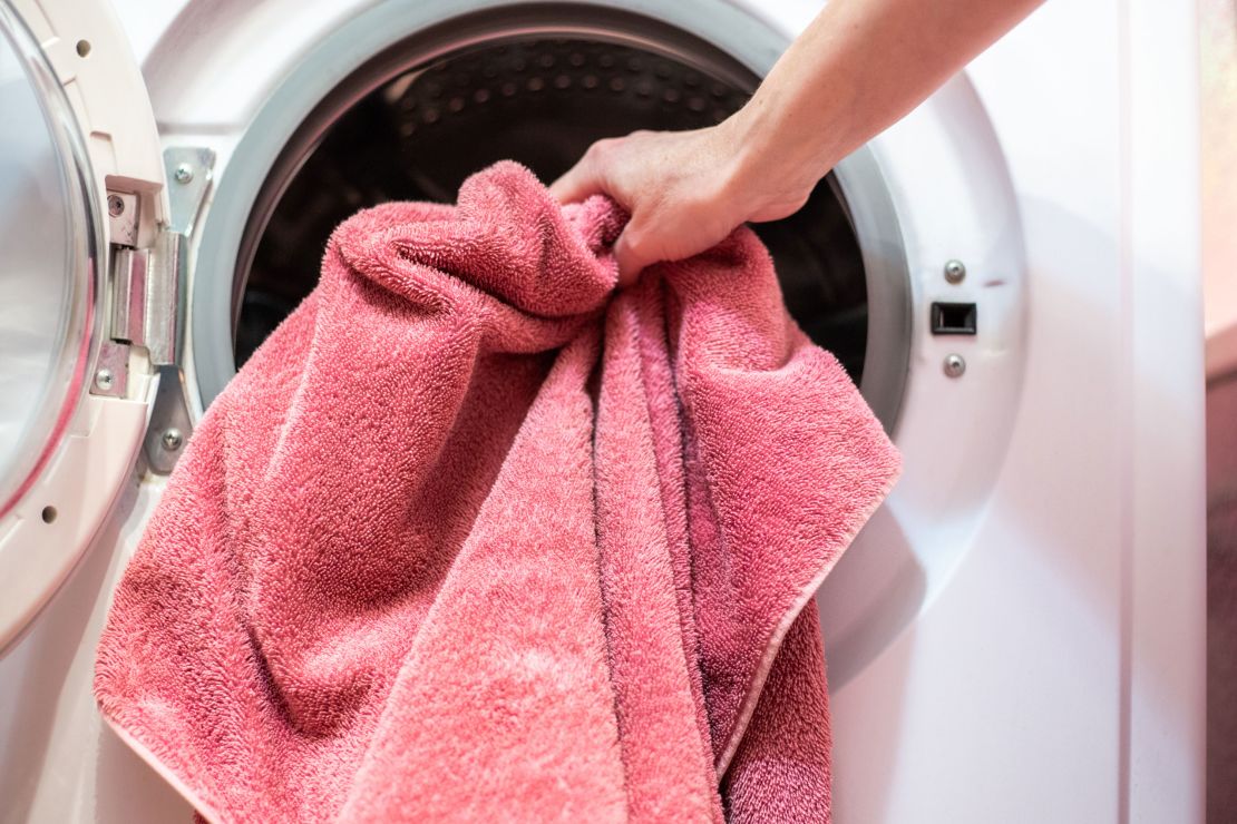 loading dirty laundry into a washing machine