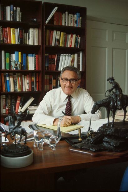 Kissinger poses for a photo in his office in Washington, DC.
