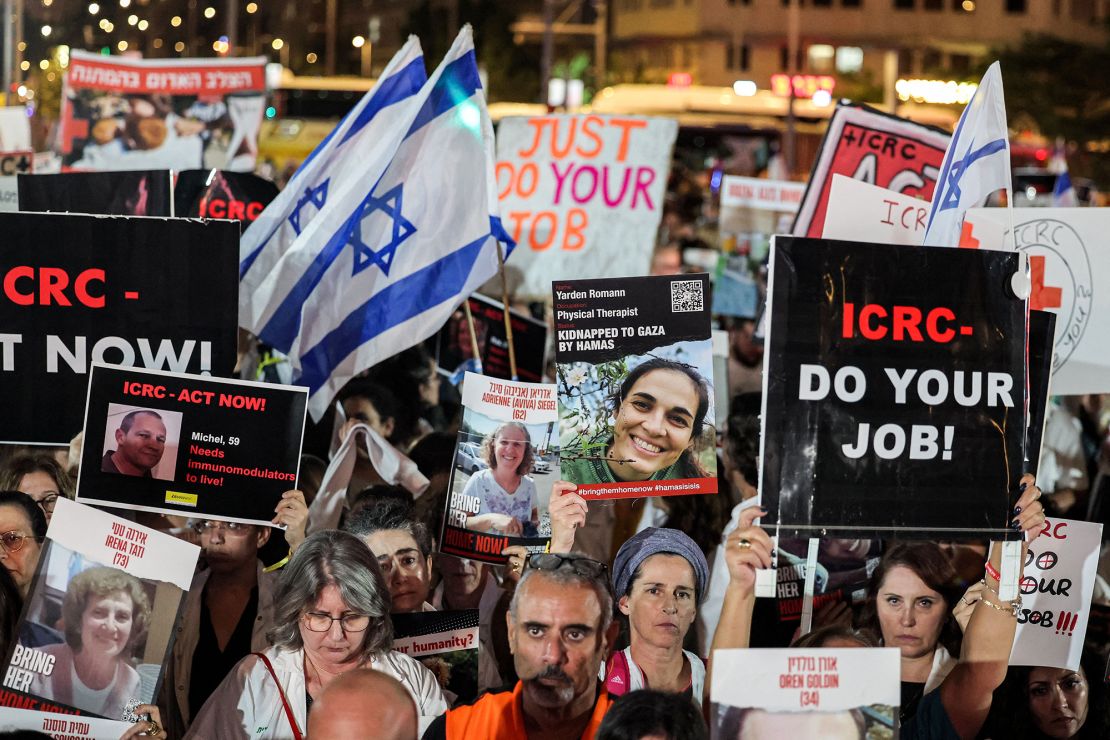 La gente se reúne con carteles para una manifestación que pide al Comité Internacional de la Cruz Roja (CICR) que tome medidas para la liberación de los rehenes secuestrados por militantes palestinos el 7 de octubre y actualmente retenidos en la Franja de Gaza, frente a las oficinas del CICR en Tel Aviv el 9 de noviembre de 2023 en medio de los combates en curso entre Israel y el grupo palestino Hamas. (Foto de AHMAD GHARABLI/AFP) (Foto de AHMAD GHARABLI/AFP vía Getty Images)