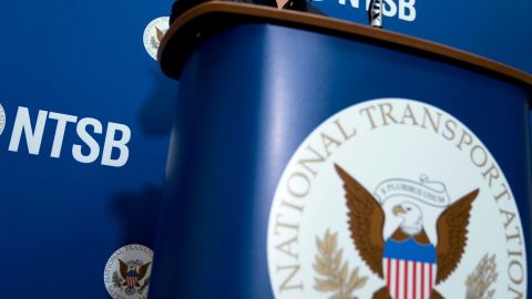 The National Transportation Safety Board logo and signage are seen at a news conference at NTSB headquarters in Washington, Dec. 18, 2017.