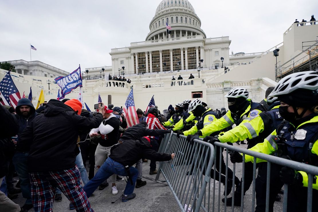 FILE - Rioters loyal to President Donald Trump rally at the U.S. Capitol in Washington on Jan. 6, 2021. Court arguments have begun in the efforts to use an insurrection clause in the U.S. Constitution to bar former President Donald Trump from running for his old job again. Testimony on Monday, Oct. 30, 2023, is focusing on whether the violent Jan. 6, 2021, assault on the U.S. Capitol was an insurrection as defined by the 14th Amendment and whether Trump's role in it meets the provision's threshold for being barred from public office. (AP Photo/Julio Cortez, File)