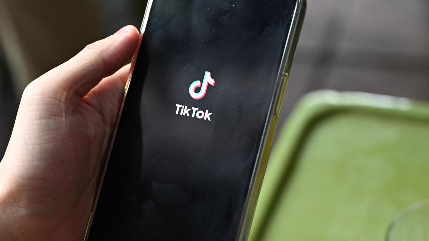 The logo of the social media platform TikTok is displayed on a mobile phone in Hanoi on October 6, 2023. Social media platforms operating in Vietnam including TikTok and Facebook removed nearly 800 posts containing "false or anti-state" information over the course of a month, state media said October 6, citing government figures. (Photo by Nhac NGUYEN / AFP) (Photo by NHAC NGUYEN/AFP via Getty Images)