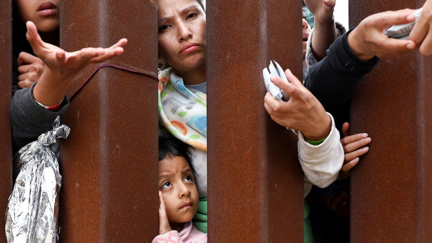 SAN DIEGO, CALIFORNIA - MAY 13: Ecuadorian mother Miriam stands with her daughter Aylin, 4, as they await volunteer assistance while stuck in a makeshift camp amongst border walls, between the U.S. and Mexico on May 13, 2023 in San Diego, California. Miriam said they had traveled for 15 days from Ecuador with four other females and had been waiting at the camp for two days. Some of the migrants at the open-air camp have been waiting for days in limbo for a chance to plead for asylum while local volunteer groups are providing food and other necessities. The U.S. government's Covid-era Title 42 policy, which for the past three years had allowed for the quick expulsion of irregular migrants entering the country, expired on the evening of May 11. (Photo by Mario Tama/Getty Images)