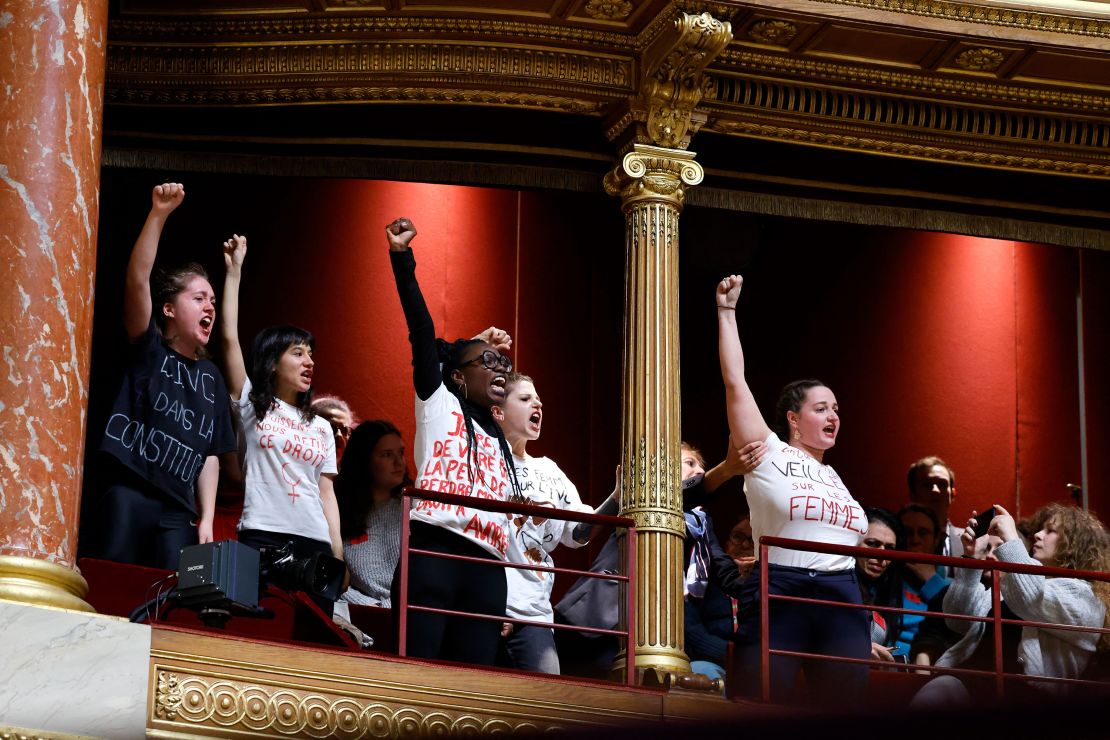 Protestors voice their support for abortion rights from a balcony as security staff (3rd R) attempt to remove them during a debate on a draft law on the constitutionalisation of the right to abortion at the Senate in Paris, on February 1, 2023.