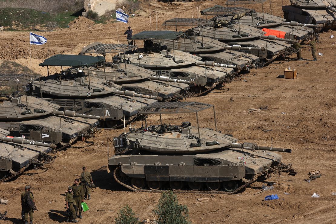 Israeli troops gather with their military vehicles on the border with the Gaza Strip on November 30, 2023, on the 7th day of a truce in battles between Israel and Hamas militants. Israel and Hamas have agreed to extend by one more day a truce under which hostages are exchanged for Palestinian prisoners and aid flows into the war-devastated Gaza Strip. (Photo by GIL COHEN-MAGEN / AFP)