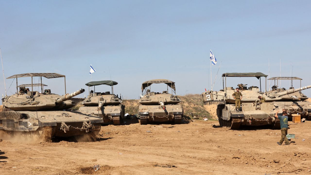 Israeli troops gather with their military vehicles on the border with the Gaza Strip on November 30, 2023, on the 7th day of a truce in battles between Israel and Hamas militants. Israel and Hamas have agreed to extend by one more day a truce under which hostages are exchanged for Palestinian prisoners and aid flows into the war-devastated Gaza Strip. (Photo by GIL COHEN-MAGEN / AFP)