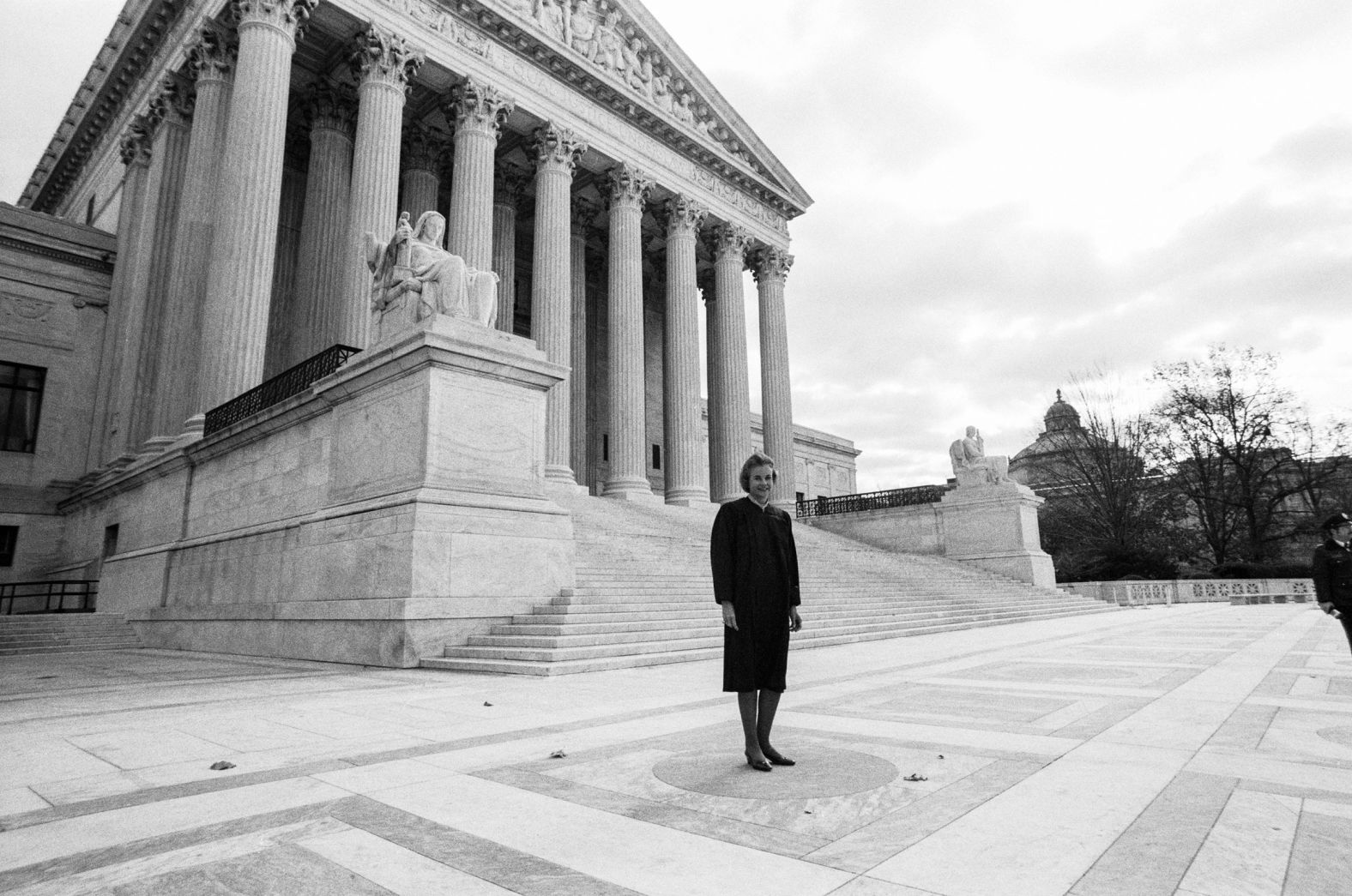 O'Connor stands in front of the Supreme Court after being sworn in as its first-ever female justice.