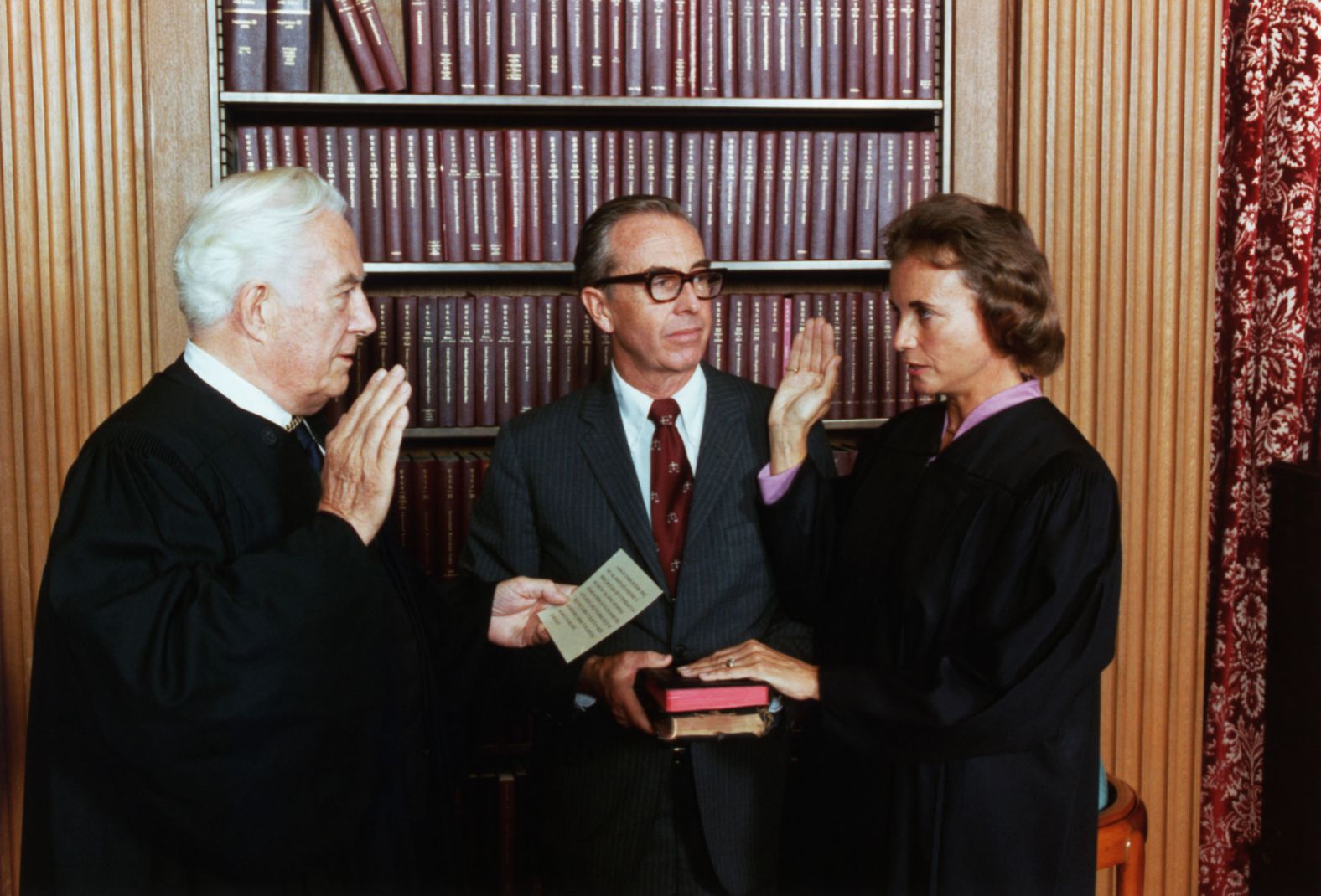 O'Connor is sworn in by Supreme Court Chief Justice Warren Burger in 1981. Her husband, John, is holding two family Bibles.
