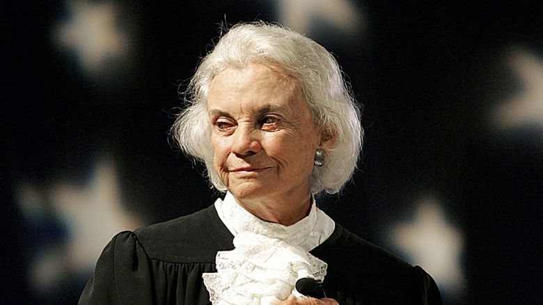 Supreme Court Justice Sandra Day O'Connor pledges alligence to the flag in this Sept. 17, 2005, file photo at an open-air Immigration and Naturalization citizenship hearing in Gilbert, Ariz.