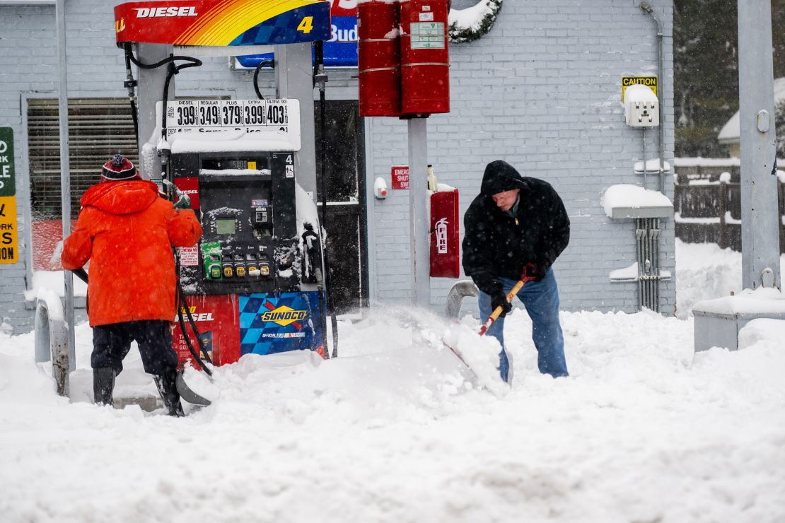STONY BROOK, NY - JANUARY 29: People shovel snow during a major snowstorm on January 29, 2022 in Stony Brook, New York. A powerful nor'easter brought blinding blizzard conditions with high winds causing widespread power outages to much of the Mid-Atlantic and New England coast.  (Photo by Andrew Theodorakis/Getty Images)