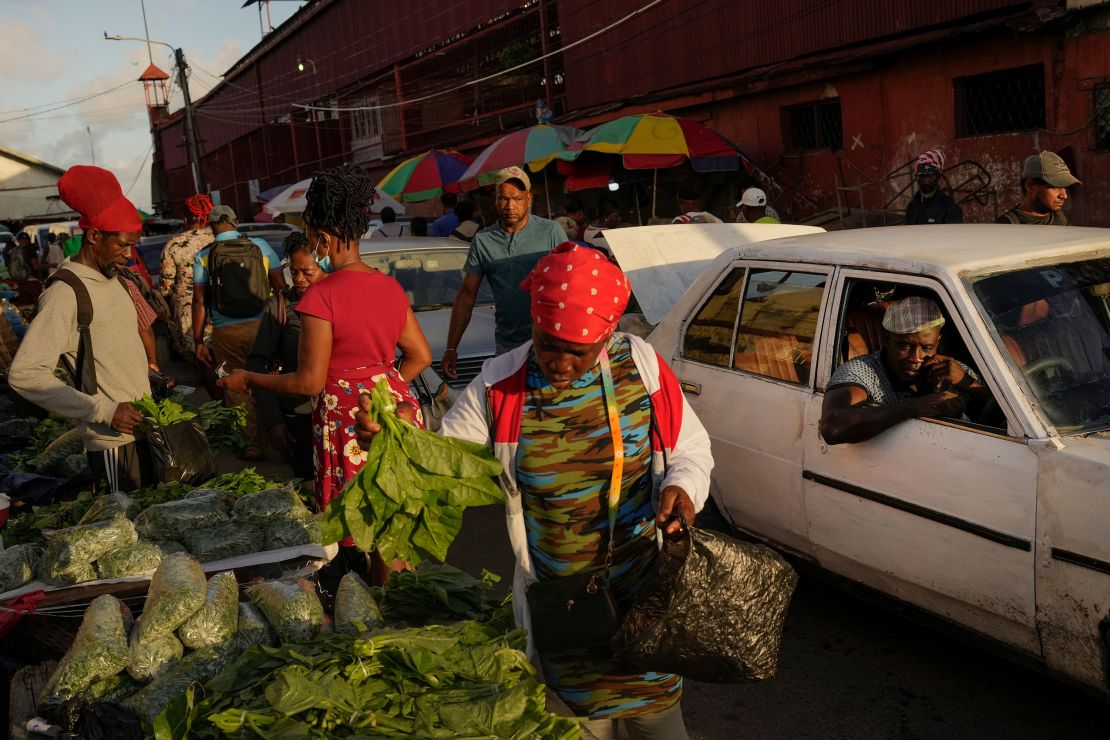 Shoppers look at vegetables at the Stabroek Market in Georgetown, Guyana, Thursday, April 13, 2023. More than 40% of the population lived on less than $5.50 a day when oil production began in December 2019. (AP Photo/Matias Delacroix)