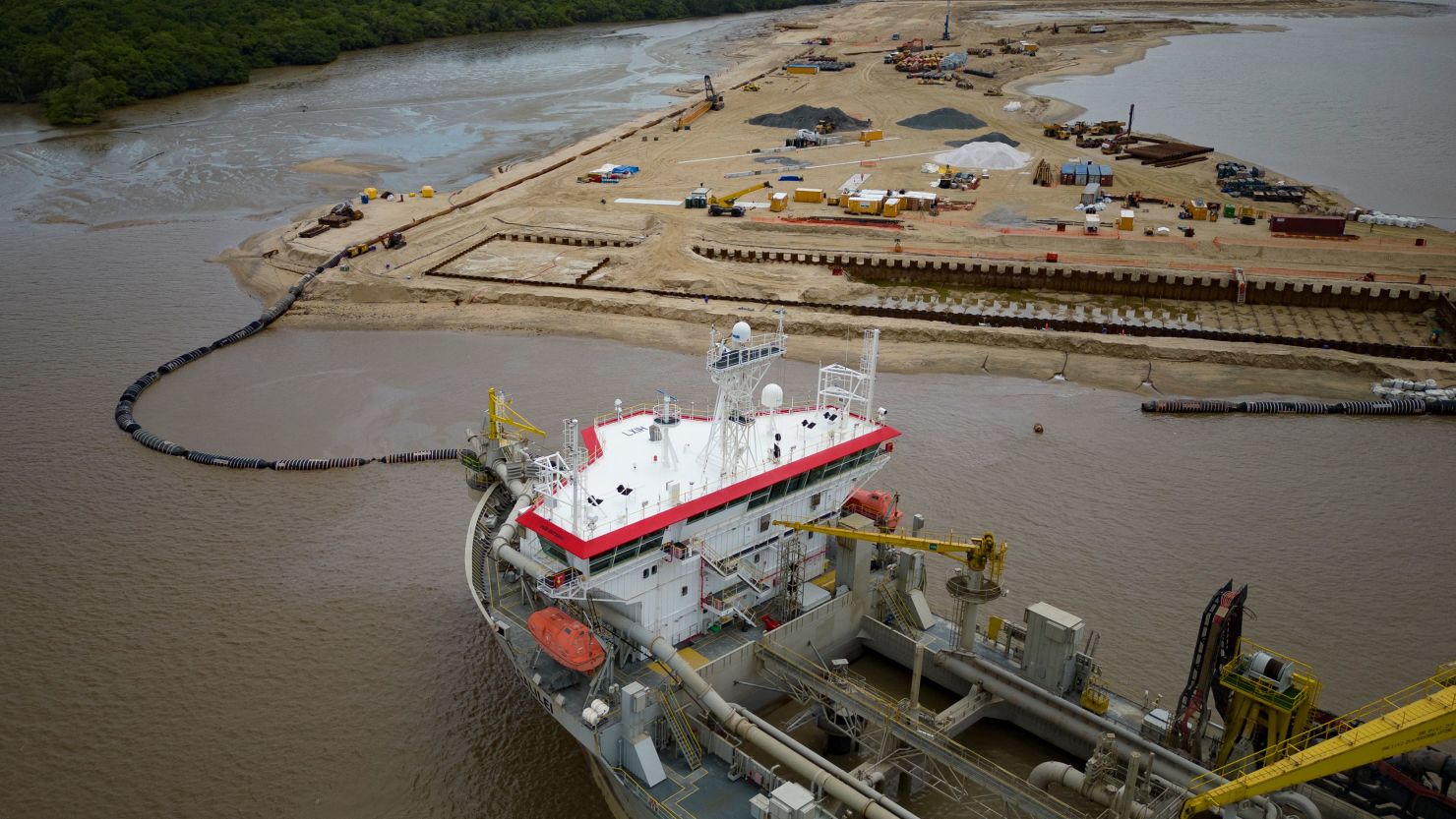 A ship creates an artificial island by extracting offshore sand to create a coastal port for offshore oil production at the mouth of the Demerara River in Georgetown, Guyana, Tuesday, April 11, 2023. Guyana is poised to become the world's fourth-largest offshore oil producer, placing it ahead of Qatar, the United States, Mexico and Norway. (AP Photo/Matias Delacroix)