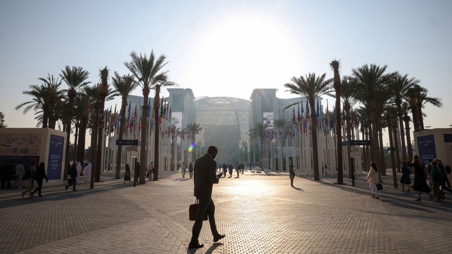 Attendees arrive at the Blue Zone on day three of the COP28 climate conference at Expo City in Dubai, United Arab Emirates, on Saturday, Dec. 2, 2023. More than 70,000 politicians, diplomats, campaigners, financiers and business leaders will fly to Dubai to talk about arresting the world's slide toward environmental catastrophe. Photographer: Annie Sakkab/Bloomberg