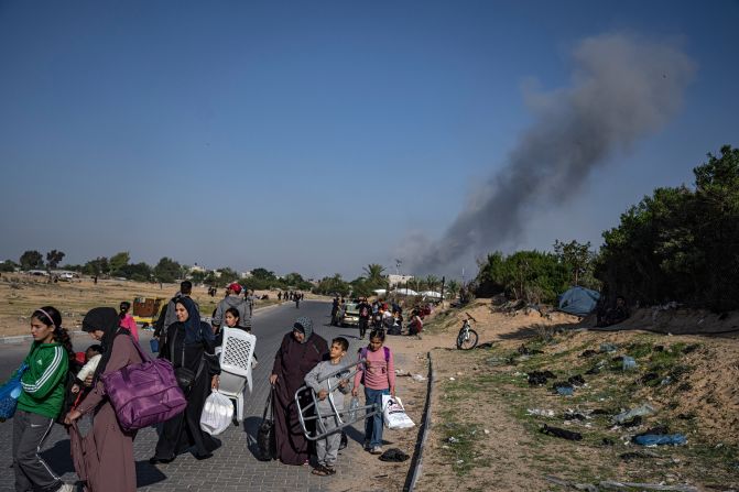 Palestinians carry belongings as they flee their homes on December 2, in Khan Younis, Gaza.