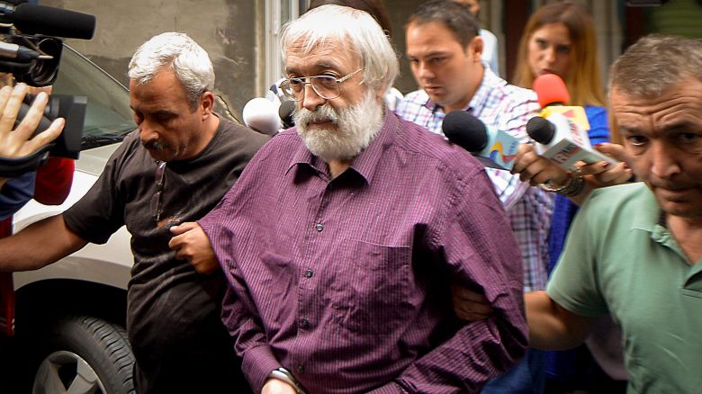 Romanian guru Gregorian Bivolaru is escorted to a vehicle, after a hearing at the Romanian Police headquarters in Bucharest, Romania, Wednesday, Aug. 24, 2016. French authorities arrested the leader of a multinational tantric yoga organization Tuesday Nov. 28, 2023 on suspicion of indoctrinating female followers for sexual exploitation. The Romanian guru at the heart of the Atman Yoga Federation was detained during a massive morning police operation across the Paris region.