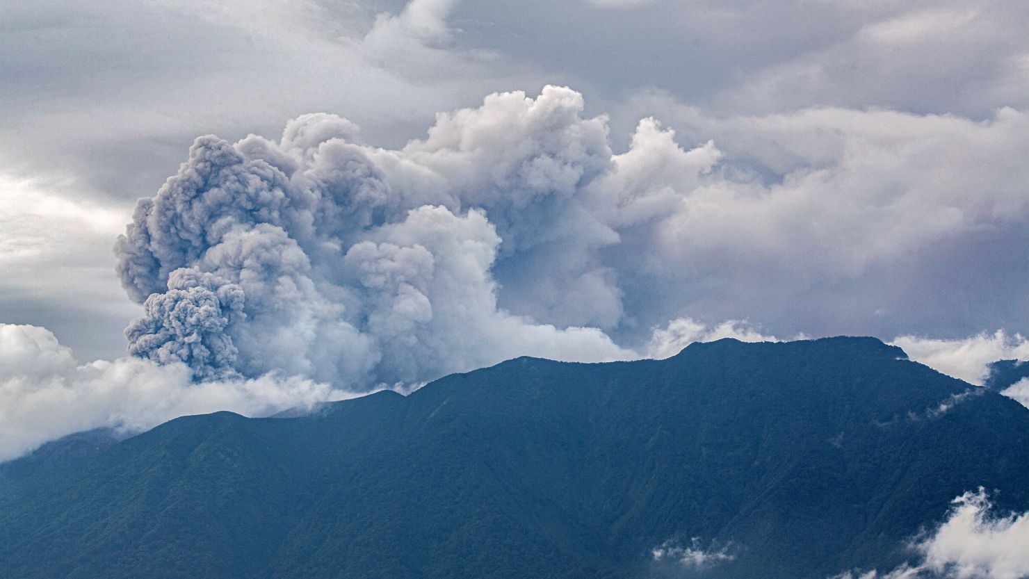 Volcanic ash spews from Mount Marapi during an eruption as seen from Tanah Datar in West Sumatra on December 3, 2023. A volcano in western Indonesia erupted on December 3, belching a column of ash around three kilometres into the sky and forcing the evacuation of dozens of hikers, officials said.