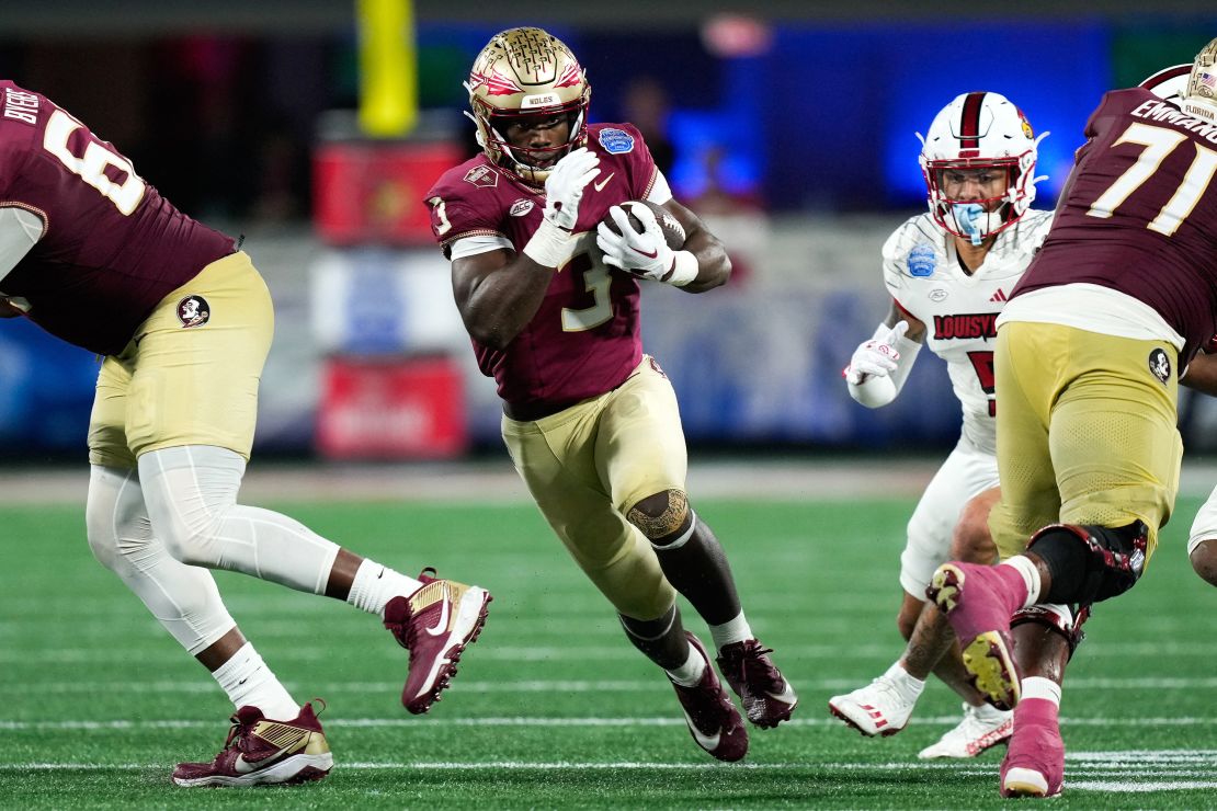 Dec 2, 2023; Charlotte, NC, USA; Florida State Seminoles running back Trey Benson (3) runs the ball against the Louisville Cardinals during the fourth quarter at Bank of America Stadium.